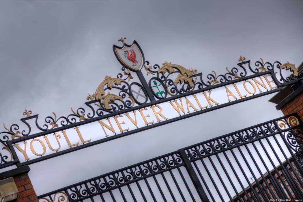 The words 'You'll Never Walk Alone' from the club's adopted anthem feature on the club crest and on the Shankly Gate entrance to Anfield stadium, the home stadium of Liverpool football club. (Photo © VisitBritain/Rod Edwards).