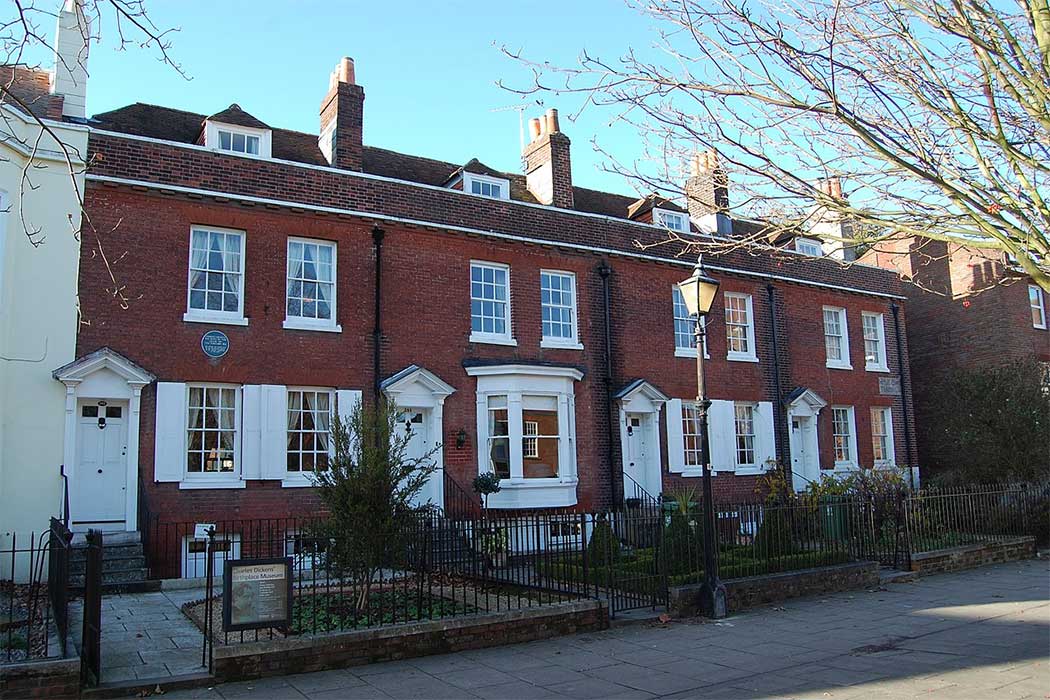 Charles Dickens was born at 393 Old Commercial Road in Portsmouth (the terraced house on the left). Dickens’ birthplace has a Grade I listing and the other three houses in the terrace are Grade II listed. 