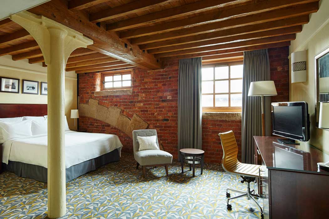 Rooms at the Manchester Marriott Victoria & Albert Hotel showcase period features of the old Victorian-era warehouse including brickwork and exposed wooden beams. (Photo: Marriott)