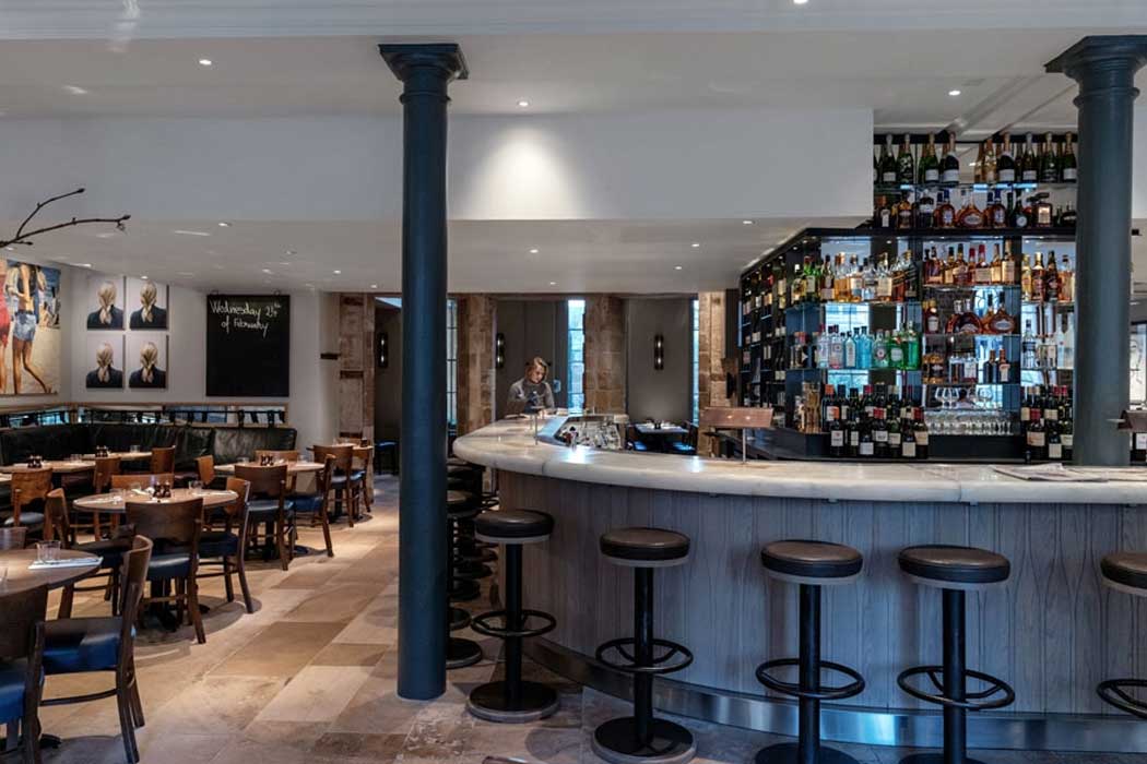 The Quod brasserie-style restaurant in the former banking hall has stone floors and a prominent oval bar