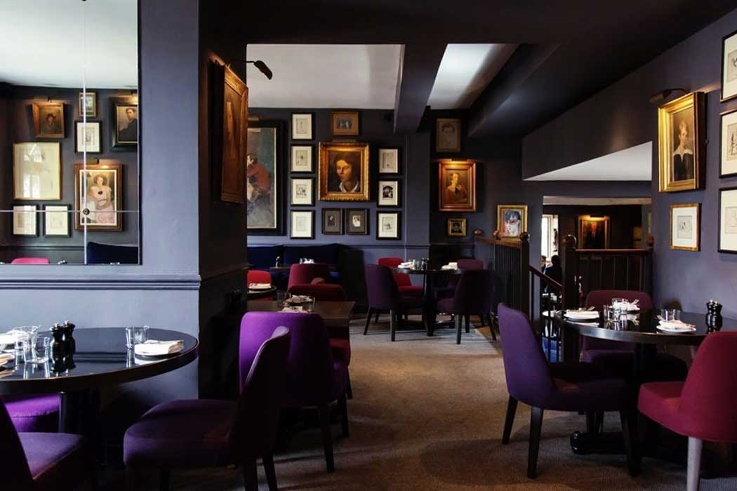 The main dining room at the Parsonage Bar and Grill has an clubby feel with original art on the walls. In many ways it is just like staying at an exclusive club.