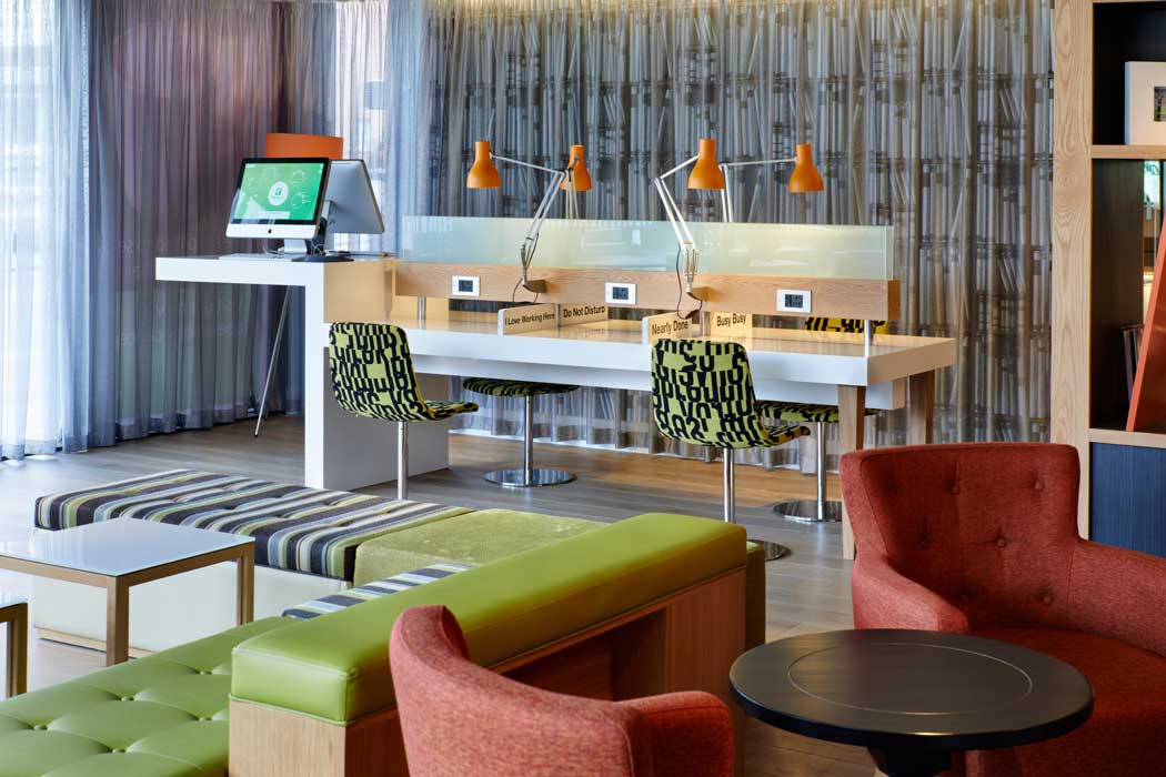 This open-plan lobby area features communal work desks that are set up like a small co-working space. This makes a nice break from working in your room. (Photo: IHG)