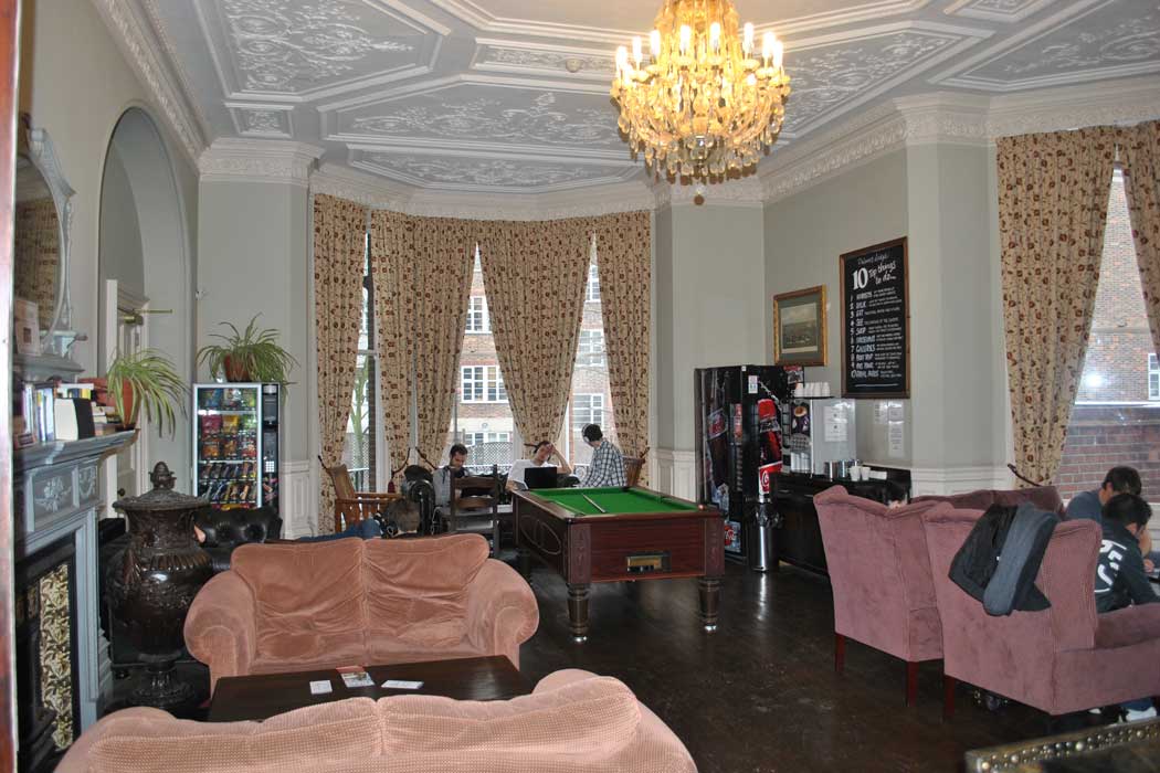 The Victorian-era building's period features include moulded ceilings and chandeliers, as you can see here in the hostel's lounge area. 