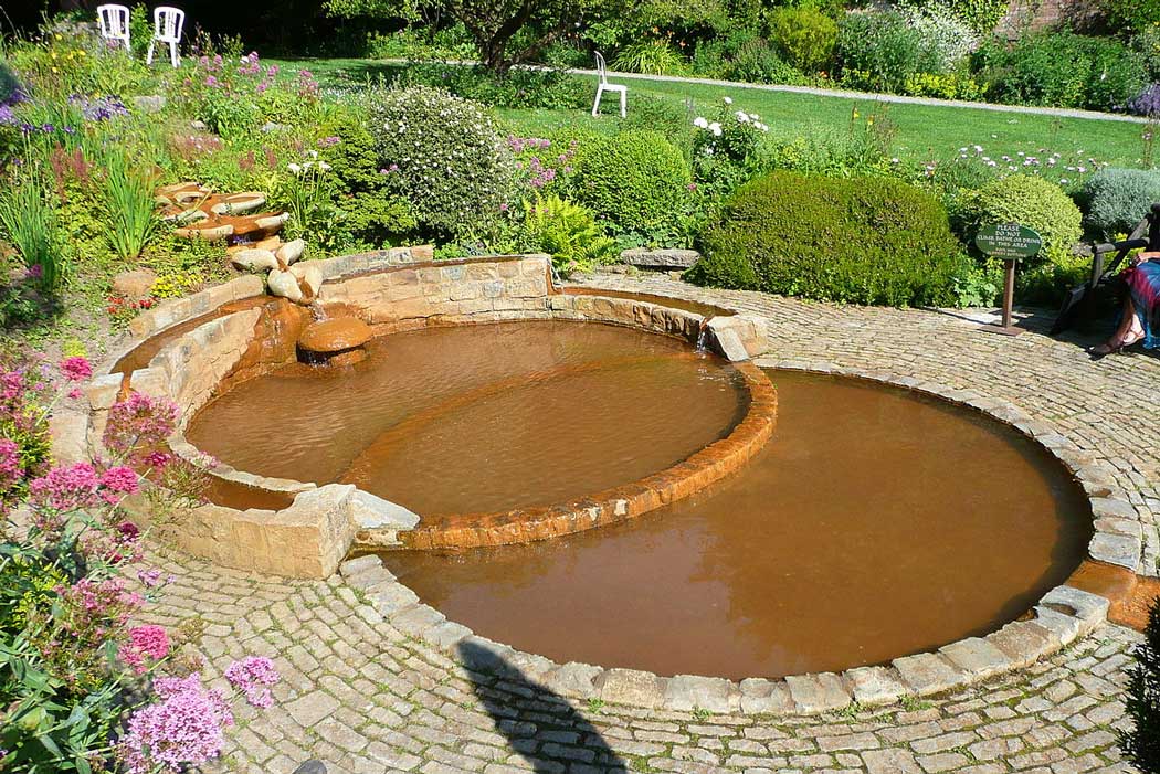 The Chalice Well Gardens contain pools designed with the same vescia piscis (fish bladder) symbolism as the well cover.