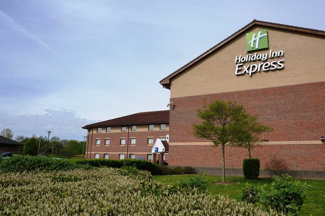 The Holiday Inn Express Taunton M5 J25 is a bland brick building in a bland office park on the outskirts of Taunton. With plenty of free parking and easy access to junction 25 of the M5 motorway, it is well suited if you're driving. (Photo: Tom Jolliffe [CC BY-SA 2.0])