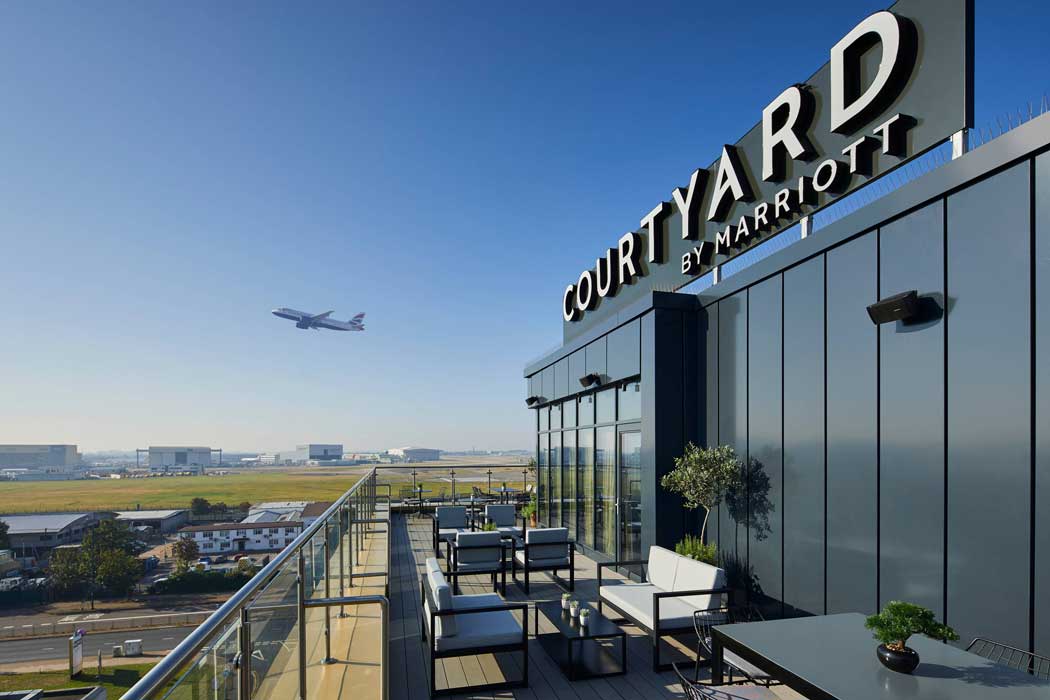 The Sky Bar on the top floor features an outdoor terrace with fantastic runway views. (Photo: Marriott)